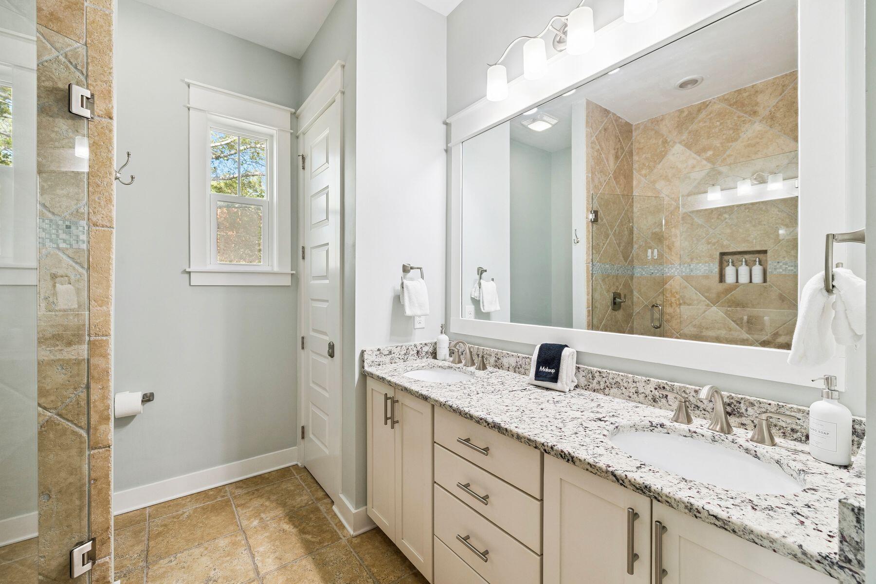 167 Milestone Drive, Unit A Inlet Beach, FL 32461 - Photo 18 of 29 a bathroom with a granite countertop sink and a mirror