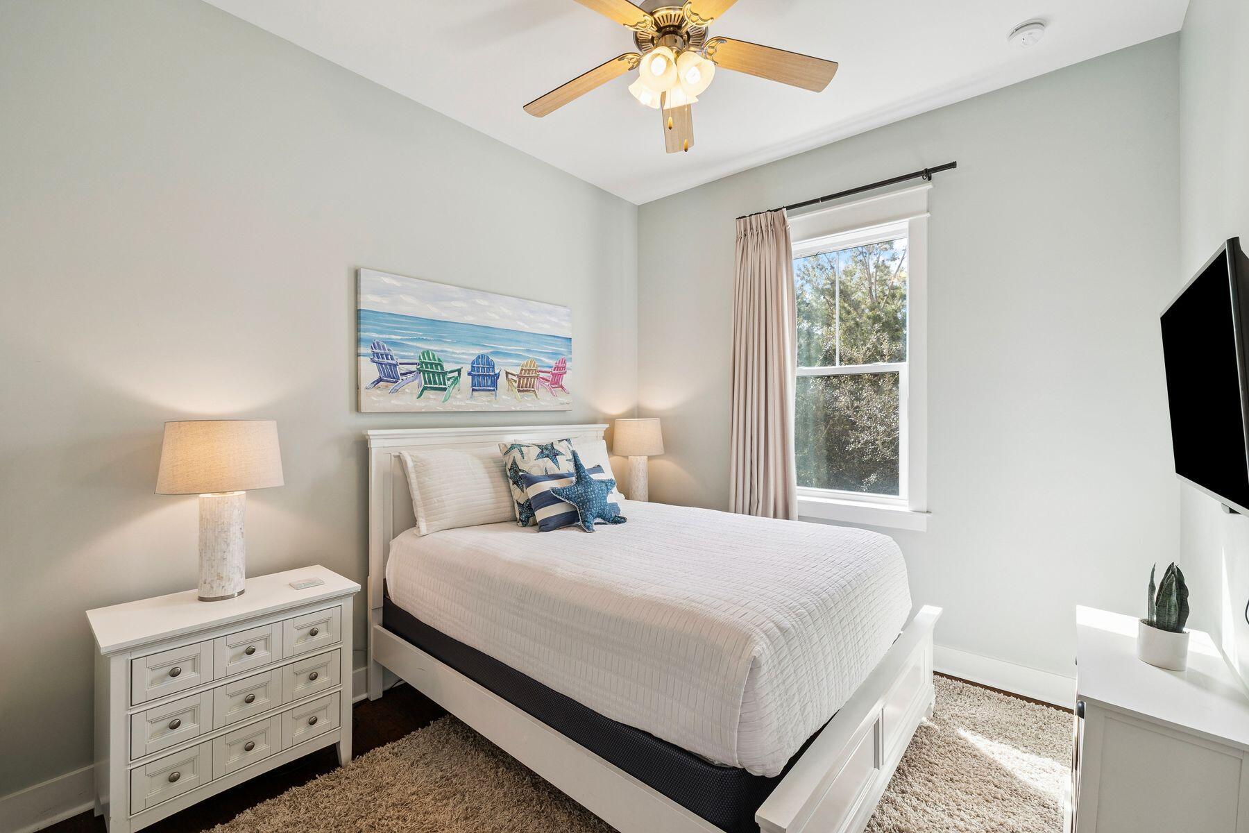 167 Milestone Drive, Unit A Inlet Beach, FL 32461 - Photo 21 of 29 a bedroom with a bed and a flat tv screen on dresser