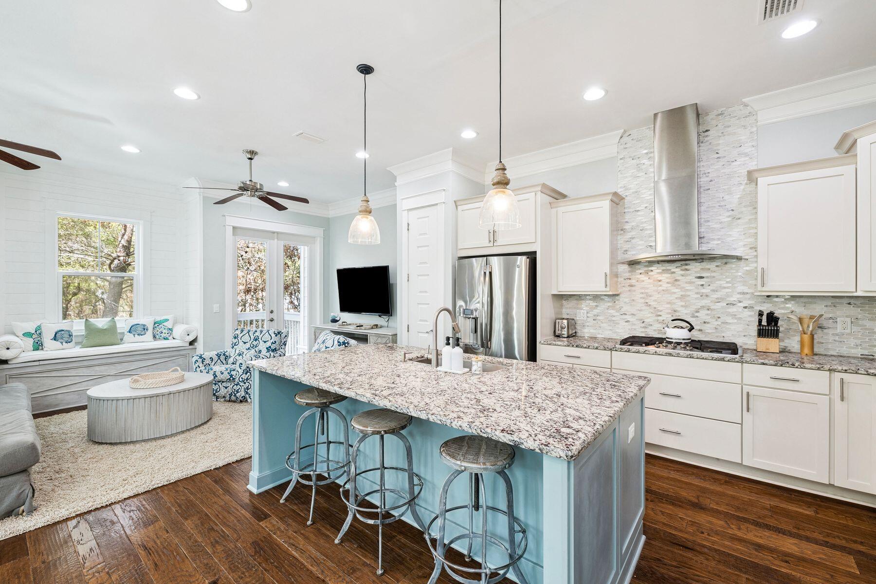 167 Milestone Drive, Unit A Inlet Beach, FL 32461 - Photo 5 of 29 a kitchen with granite countertop kitchen island stainless steel appliances a sink stove and kitchen island