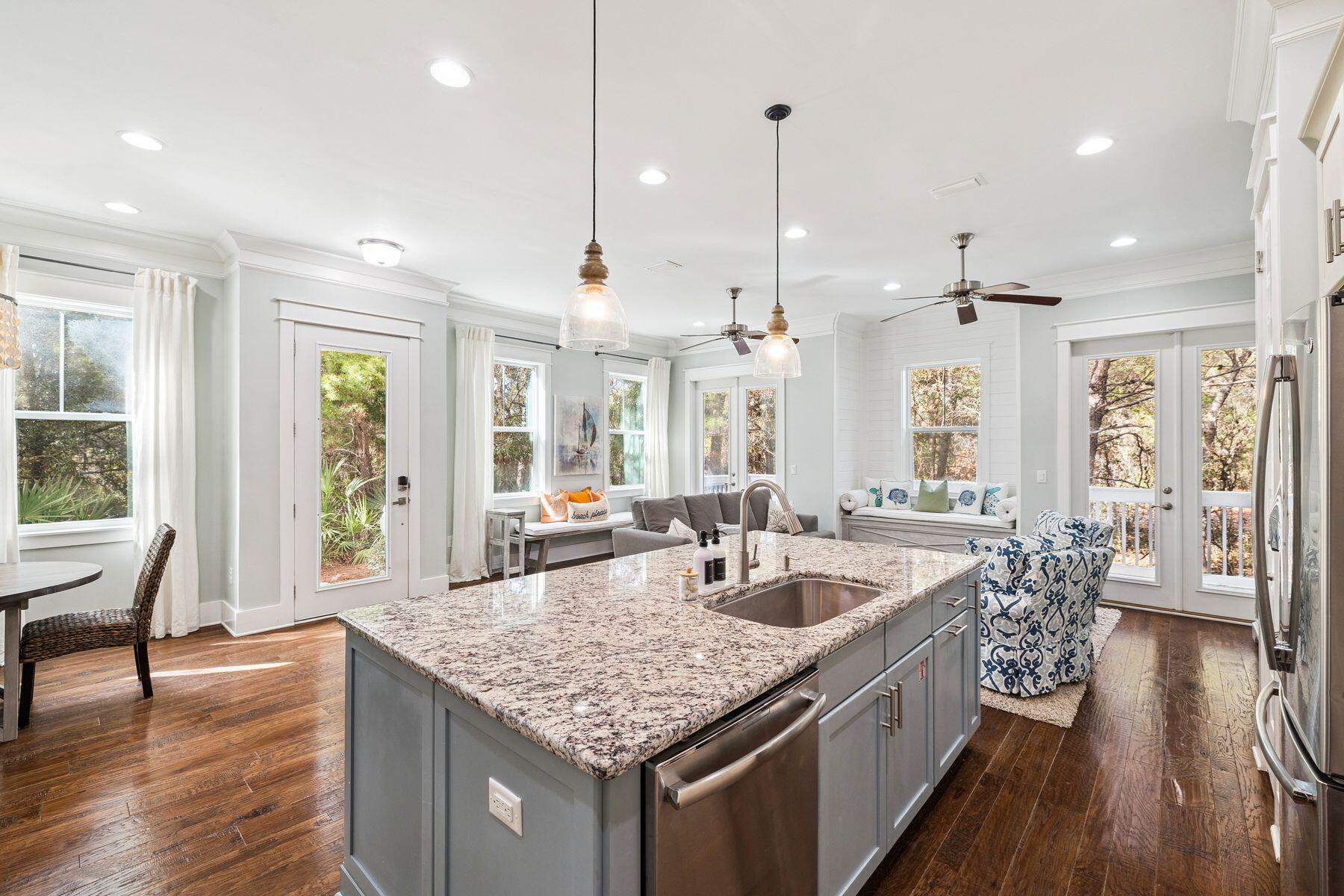 167 Milestone Drive, Unit A Inlet Beach, FL 32461 - Photo 8 of 29 a kitchen with center island wooden floor center island and stainless steel appliances