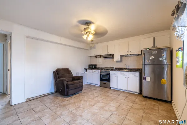 a kitchen with refrigerator and cabinets