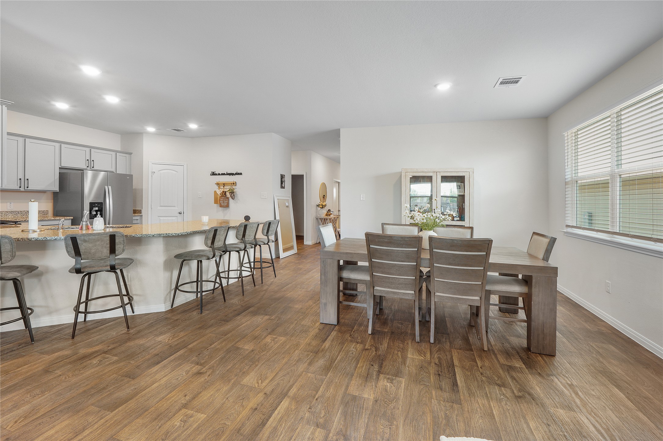 217 Evergreen Sumac Loop Kyle, TX 78640 - Photo 8 of 20 An open concept design seamlessly connects the kitchen with a spacious dining area, perfect for daily living and entertaining.