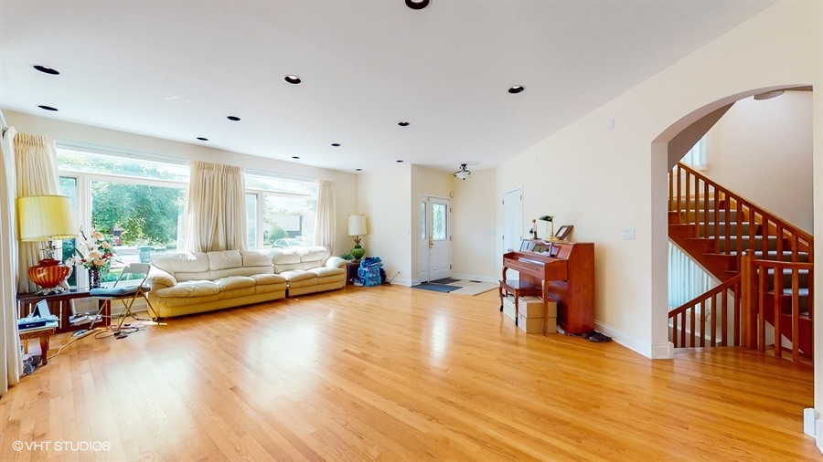 240 Hibbard Road Wilmette, IL 60091 - Photo 12 of 42 a living room with furniture and a wooden floor