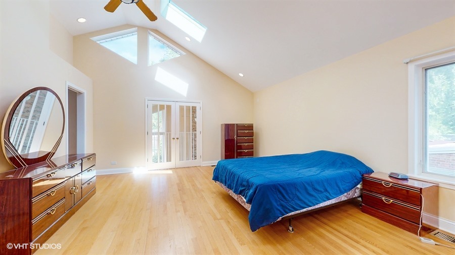240 Hibbard Road Wilmette, IL 60091 - Photo 15 of 42 a bedroom with a bed and a dresser next to a window