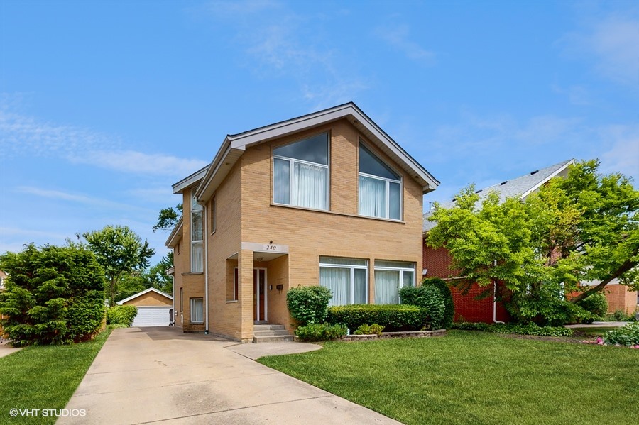 240 Hibbard Road Wilmette, IL 60091 - Photo 2 of 42 a front view of a house with a yard and trees