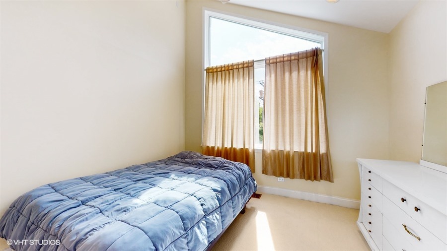 240 Hibbard Road Wilmette, IL 60091 - Photo 23 of 42 a bedroom with a bed and a window