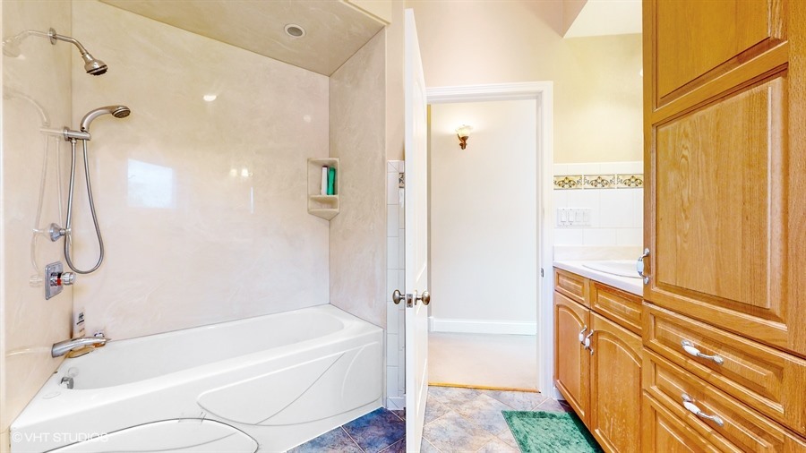 240 Hibbard Road Wilmette, IL 60091 - Photo 29 of 42 a bathroom with a bathtub and a shower