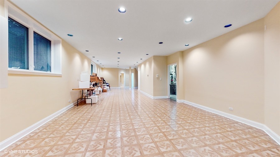240 Hibbard Road Wilmette, IL 60091 - Photo 31 of 42 a view of a hallway with wooden floor and furniture