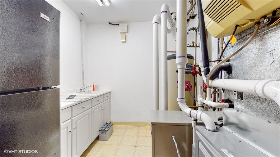 240 Hibbard Road Wilmette, IL 60091 - Photo 32 of 42 a bathroom with a double vanity sink and a mirror
