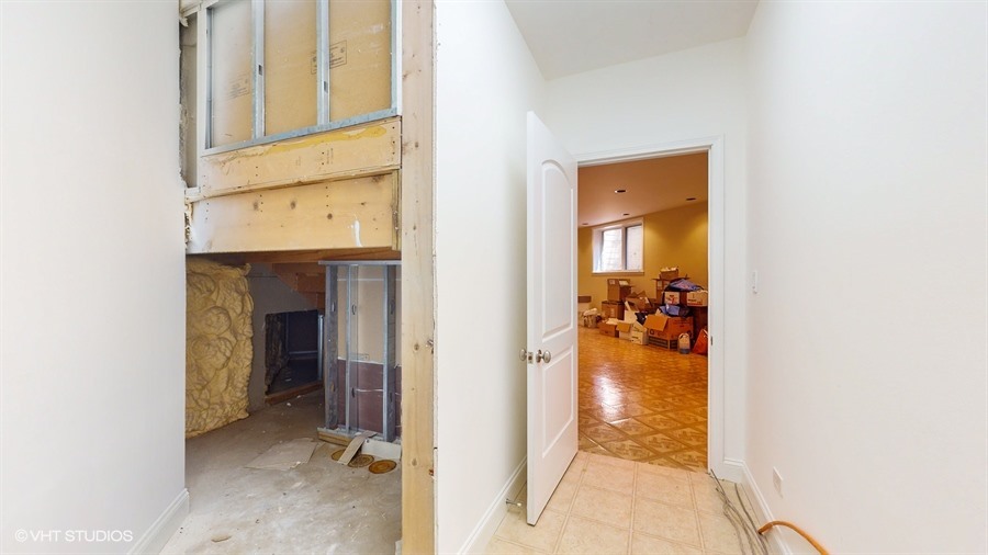 240 Hibbard Road Wilmette, IL 60091 - Photo 36 of 42 a view of a hallway with a livingroom and a bathroom with a sink