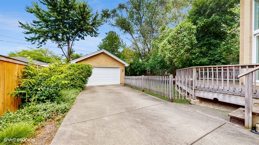 240 Hibbard Road Wilmette, IL 60091 - Photo 37 of 42 a view of a house with a small yard and large trees