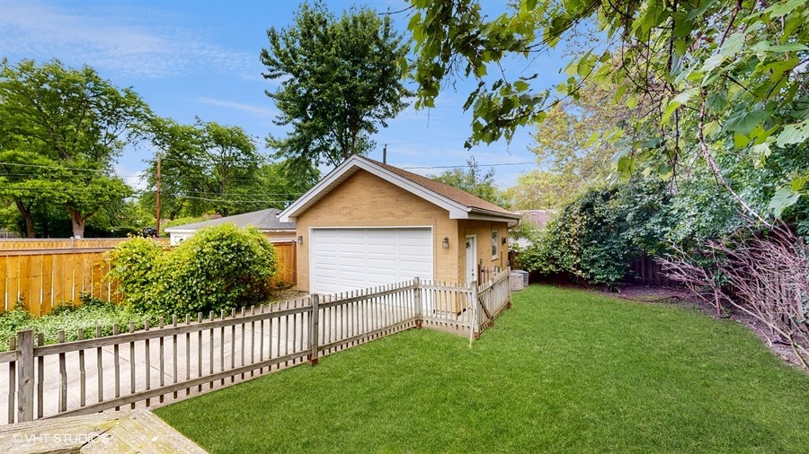 240 Hibbard Road Wilmette, IL 60091 - Photo 41 of 42 a view of a yard with wooden fence and trees