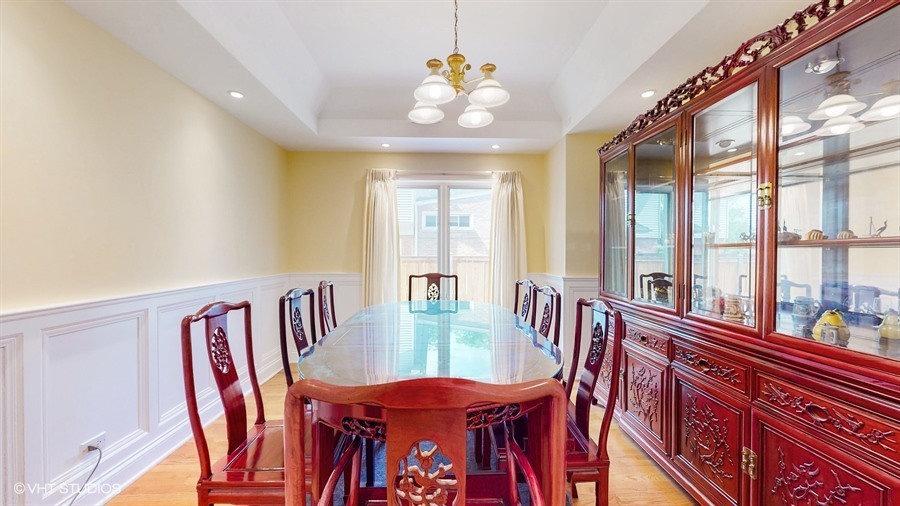 240 Hibbard Road Wilmette, IL 60091 - Photo 6 of 42 a view of a dining room with furniture large windows and wooden floor
