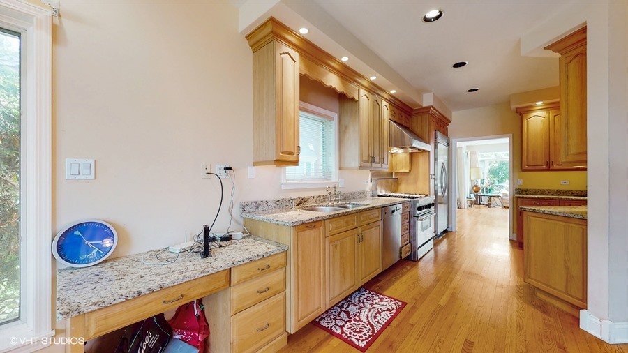 240 Hibbard Road Wilmette, IL 60091 - Photo 8 of 42 a kitchen with stainless steel appliances granite countertop a stove a sink and a refrigerator