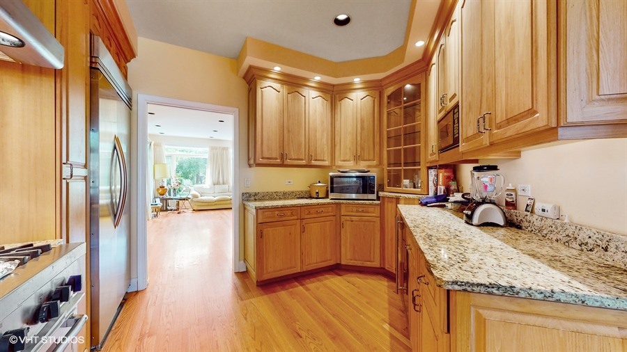 240 Hibbard Road Wilmette, IL 60091 - Photo 10 of 42 a kitchen with stainless steel appliances granite countertop sink stove and refrigerator