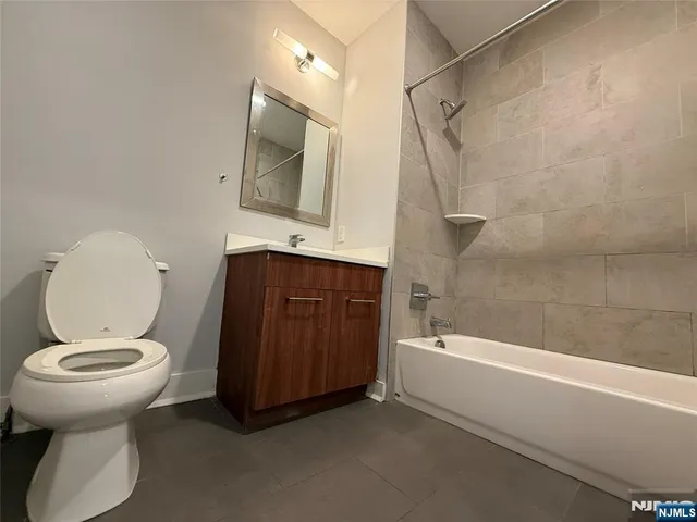 a bathroom with a toilet a sink and bathtub