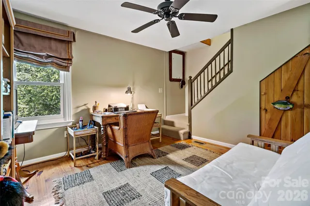 an aerial view of residential house with outdoor space and trees all around