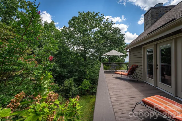 a kitchen with stainless steel appliances granite countertop a sink a stove and a wooden floors