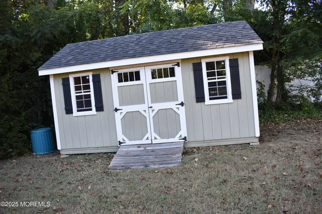 a view of a house with a yard and wooden fence