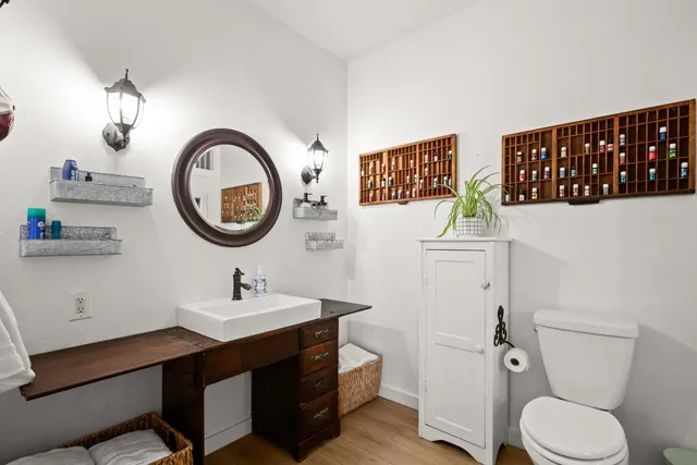 a bathroom with a toilet a sink and a mirror