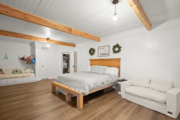 a bedroom with a bed and a couch