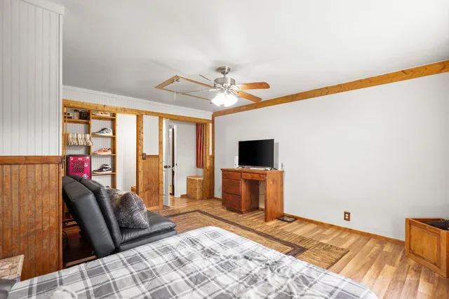 a bedroom with furniture and a flat screen tv