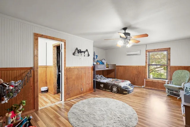 a bedroom with furniture and a window