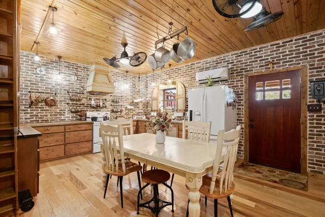 a kitchen with cabinets and wooden floor