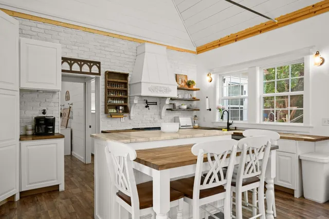 a living room with furniture wooden floor and white walls