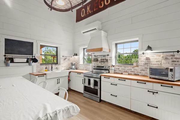a kitchen with a sink stove and cabinets