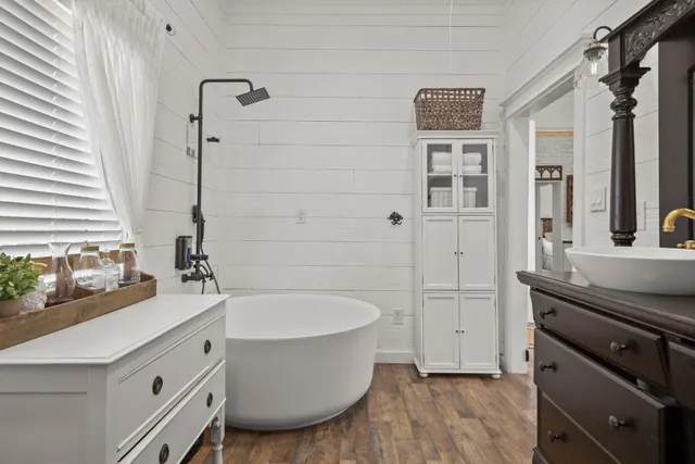 a bathroom with a sink a toilet and tub