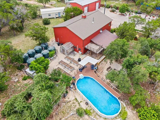 an aerial view of a house with a swimming pool