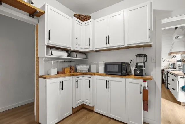a kitchen with stainless steel appliances granite countertop a sink and a refrigerator