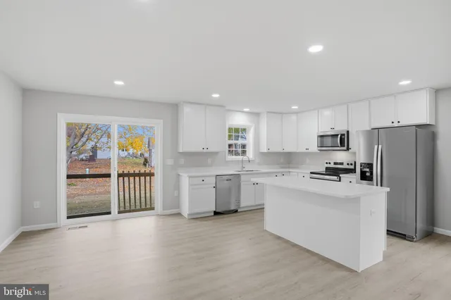 a kitchen with refrigerator and cabinets