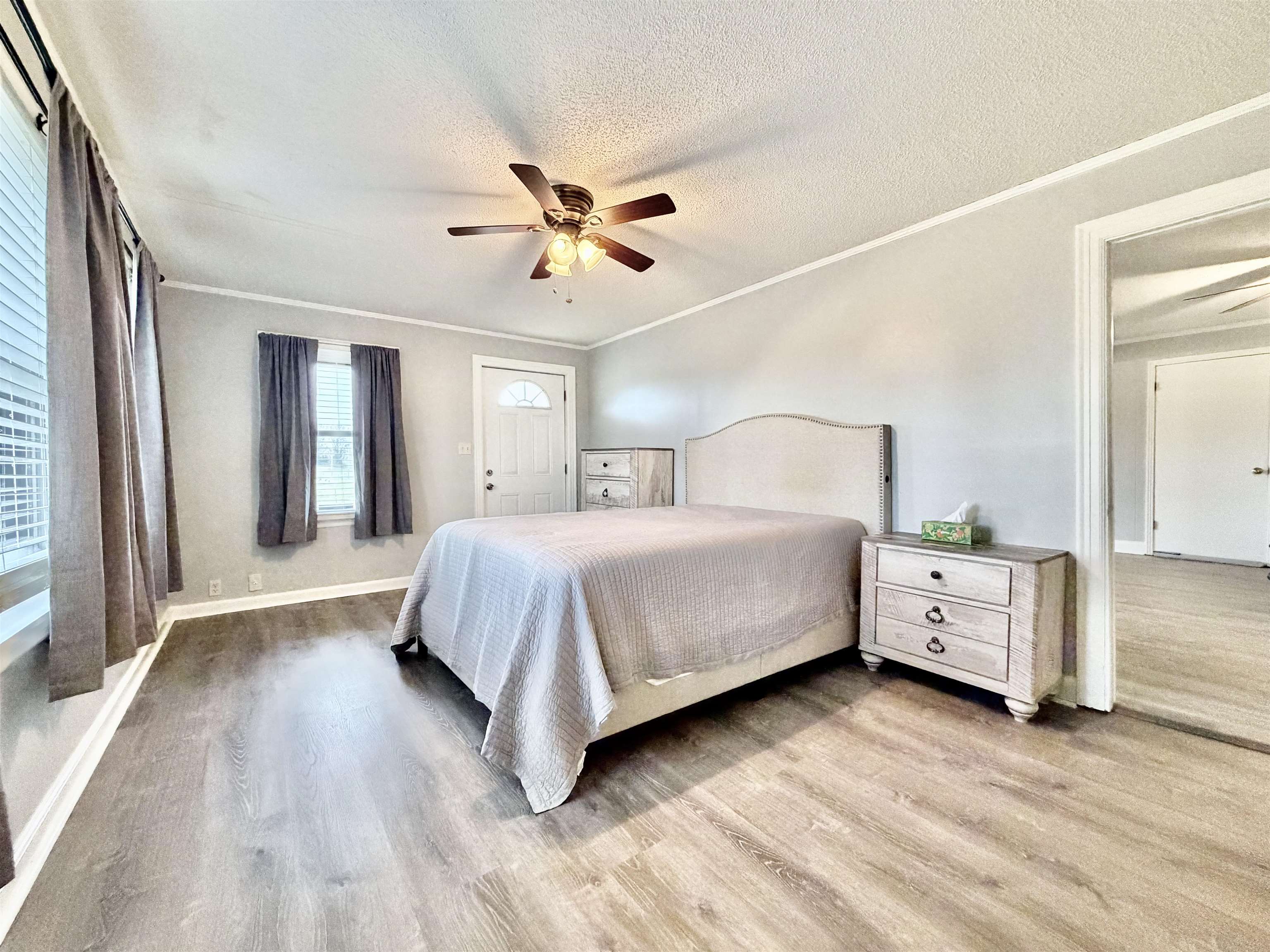 5442 Bride Road Covington, TN 38019 - Photo 13 of 19 Bedroom with light wood-style floors, ornamental molding, ceiling fan, and a textured ceiling