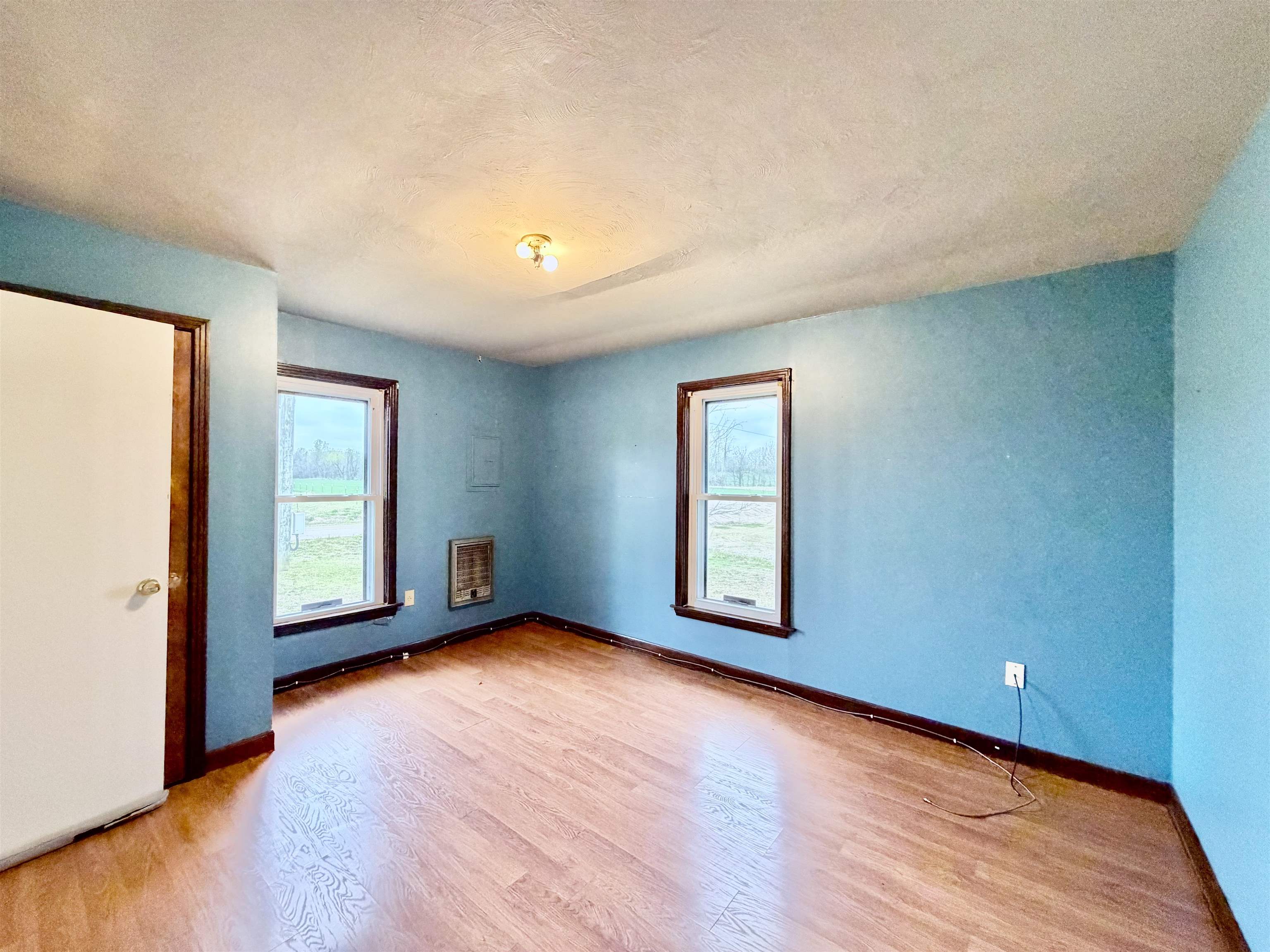 5442 Bride Road Covington, TN 38019 - Photo 15 of 19 Empty room with light wood-style floors, a textured ceiling, and heating unit