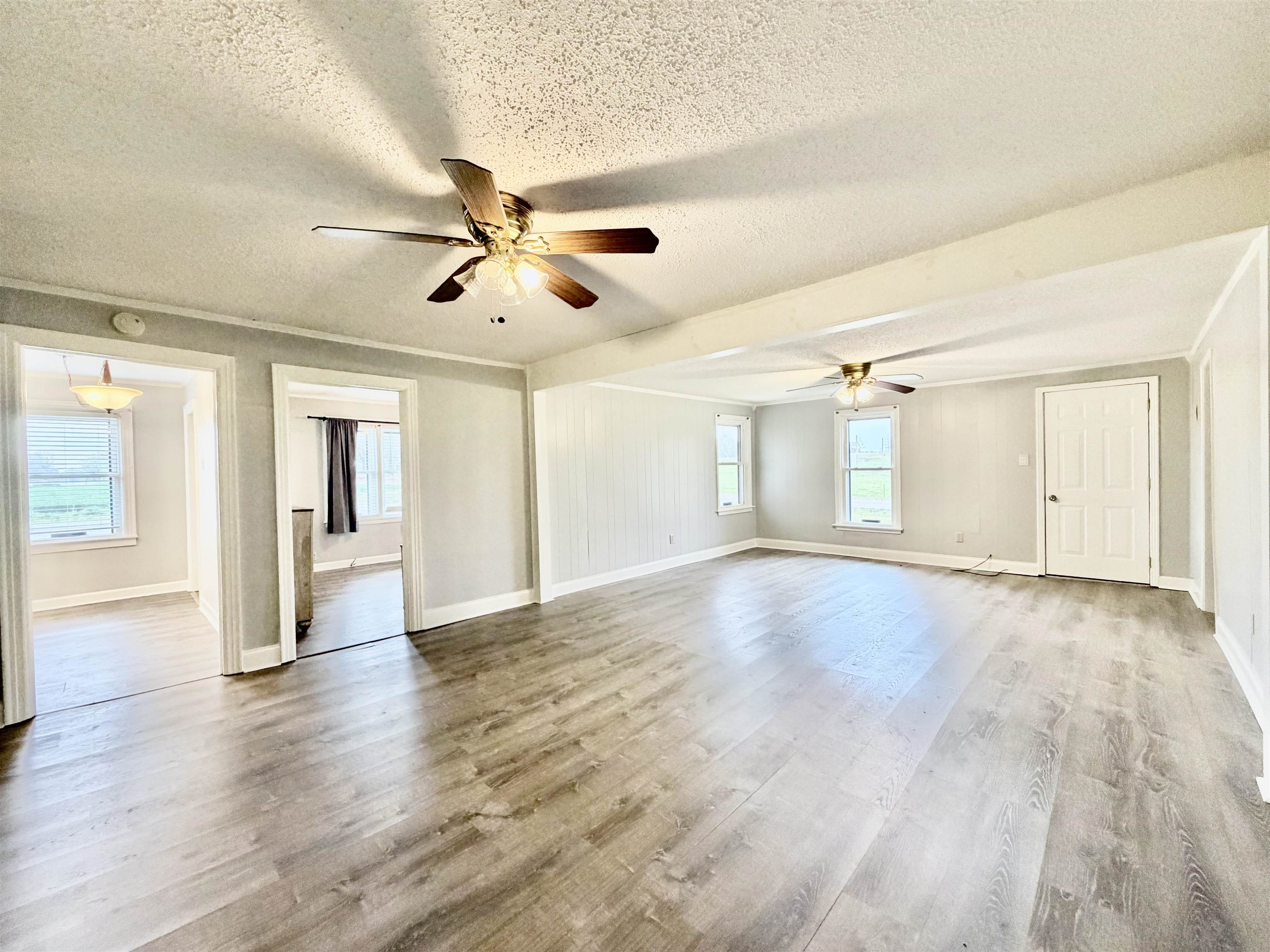 5442 Bride Road Covington, TN 38019 - Photo 7 of 19 Spare room featuring a textured ceiling, ceiling fan, and light wood-style flooring