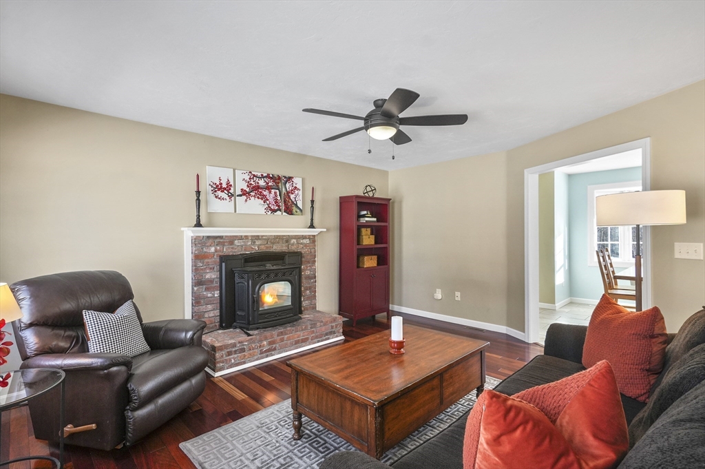 56 Glenwood Road Rutland, MA 01543 - Photo 13 of 41 a living room with furniture a table and a fireplace