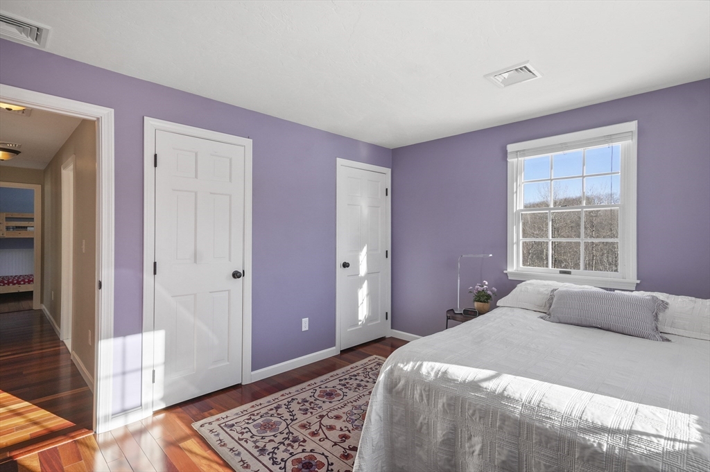 56 Glenwood Road Rutland, MA 01543 - Photo 21 of 41 a bedroom with a bed and wooden floor