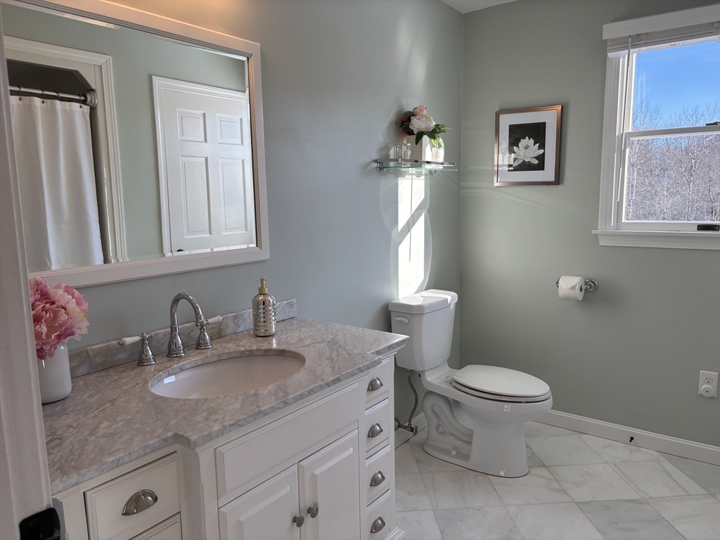 56 Glenwood Road Rutland, MA 01543 - Photo 26 of 41 a bathroom with a granite countertop sink toilet and mirror