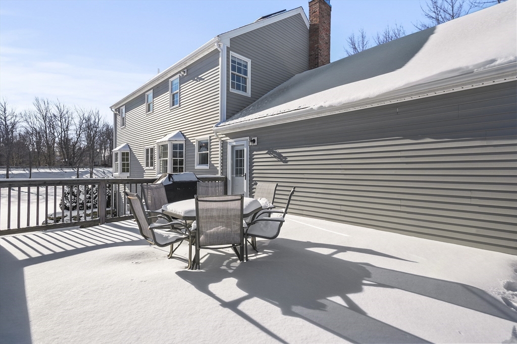 56 Glenwood Road Rutland, MA 01543 - Photo 34 of 41 a view of a roof deck with table and chairs and wooden floor