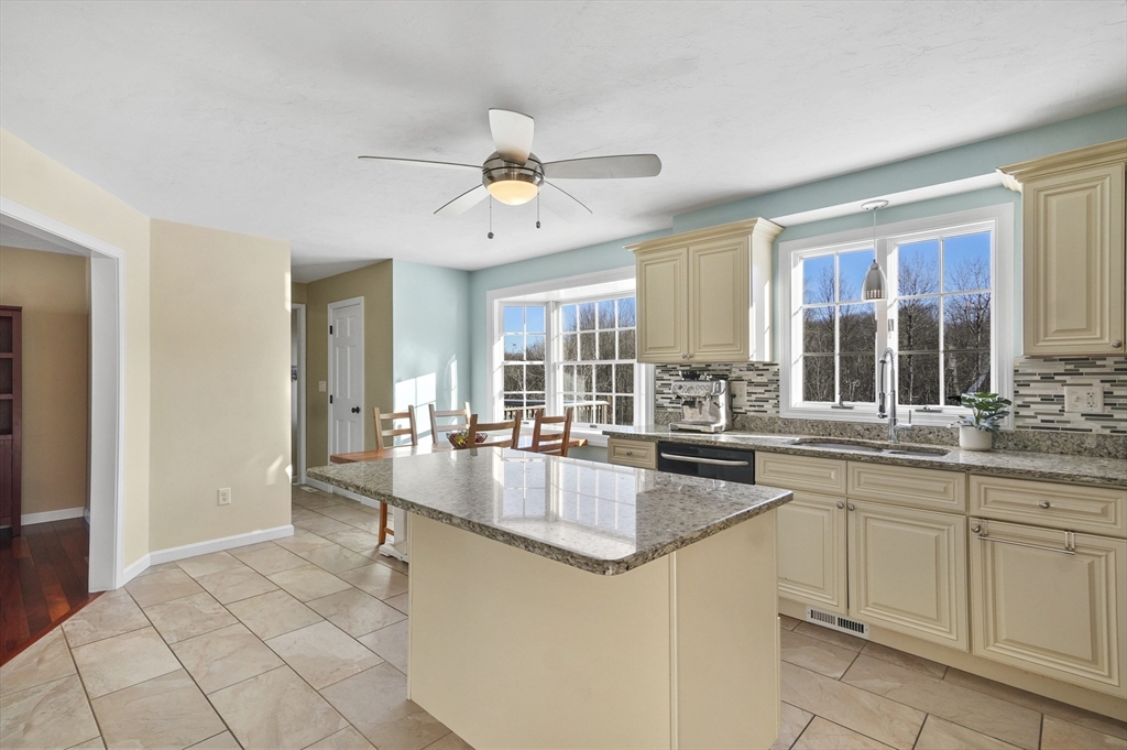 56 Glenwood Road Rutland, MA 01543 - Photo 7 of 41 a large kitchen with kitchen island granite countertop a sink and cabinets