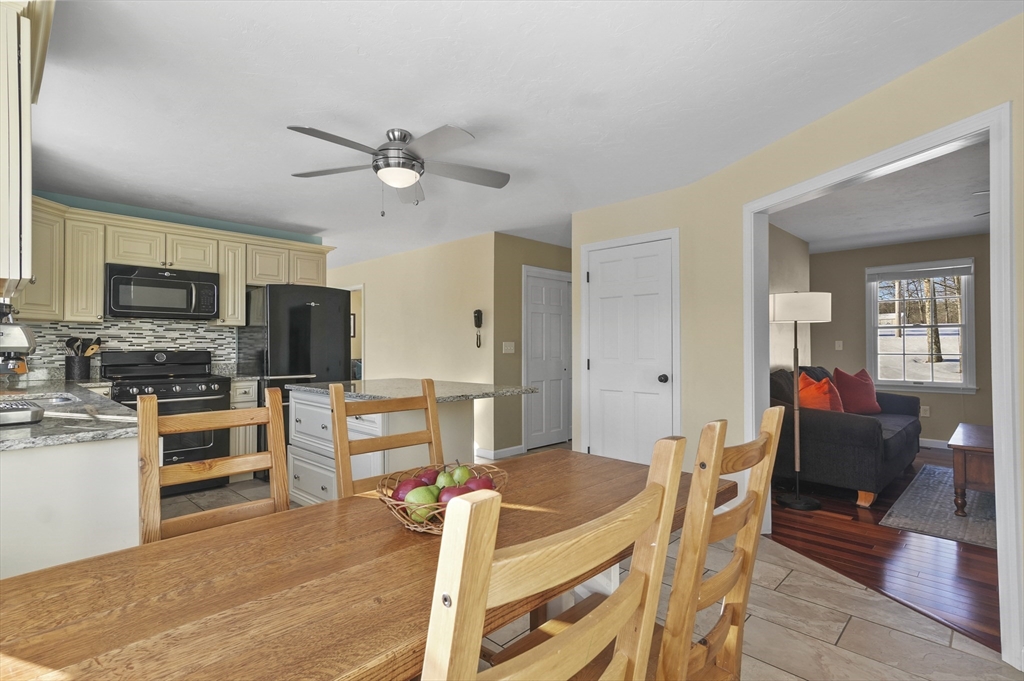 56 Glenwood Road Rutland, MA 01543 - Photo 9 of 41 a view of a dining room with furniture a kitchen and chandelier