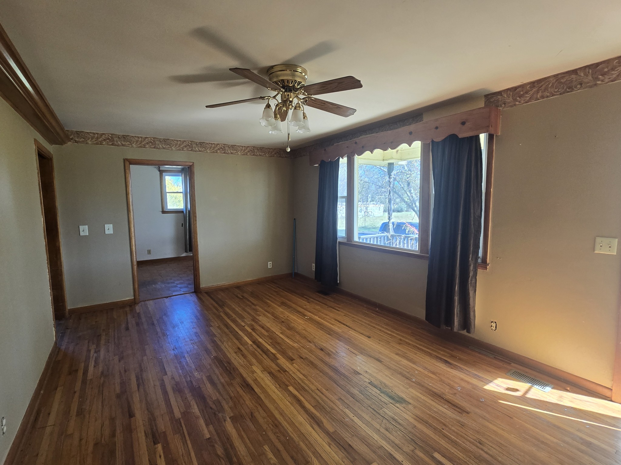 7569 Greenwood Road Cross Plains, TN 37049 - Photo 10 of 16 a view of an empty room with wooden floor and a window