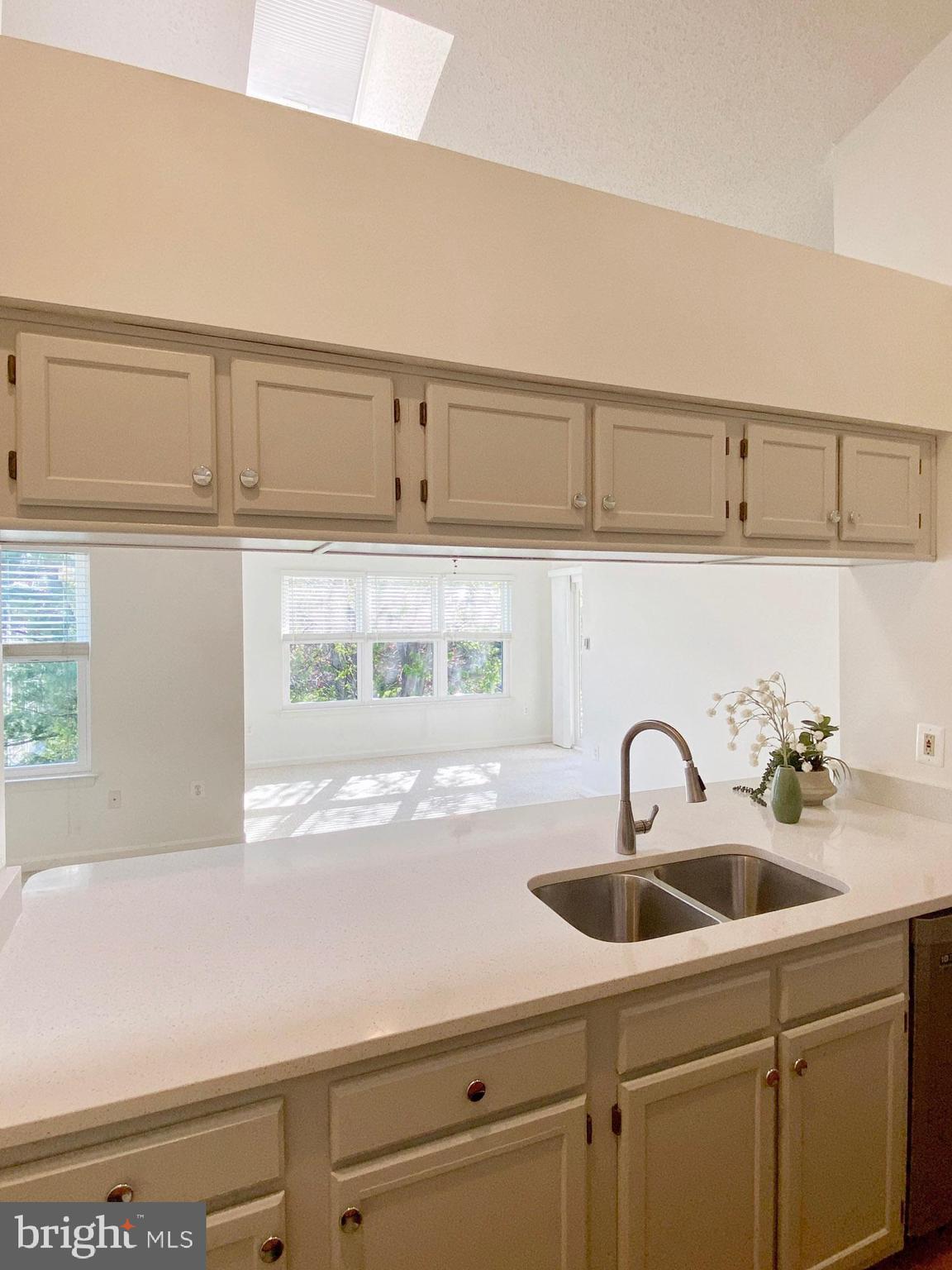 2706 Snowbird Terrace, Unit 1220 Silver Spring, MD 20906 - Photo 14 of 37 a kitchen with a sink and cabinets