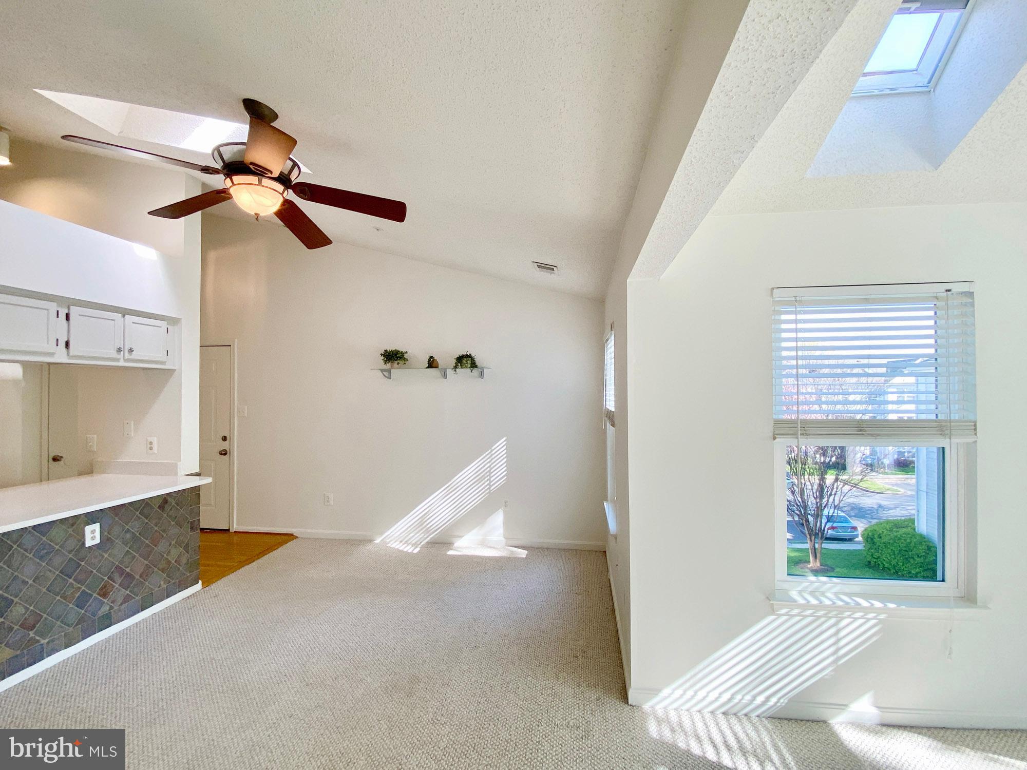 2706 Snowbird Terrace, Unit 1220 Silver Spring, MD 20906 - Photo 4 of 37 a view of a bedroom with a window and ceiling fan