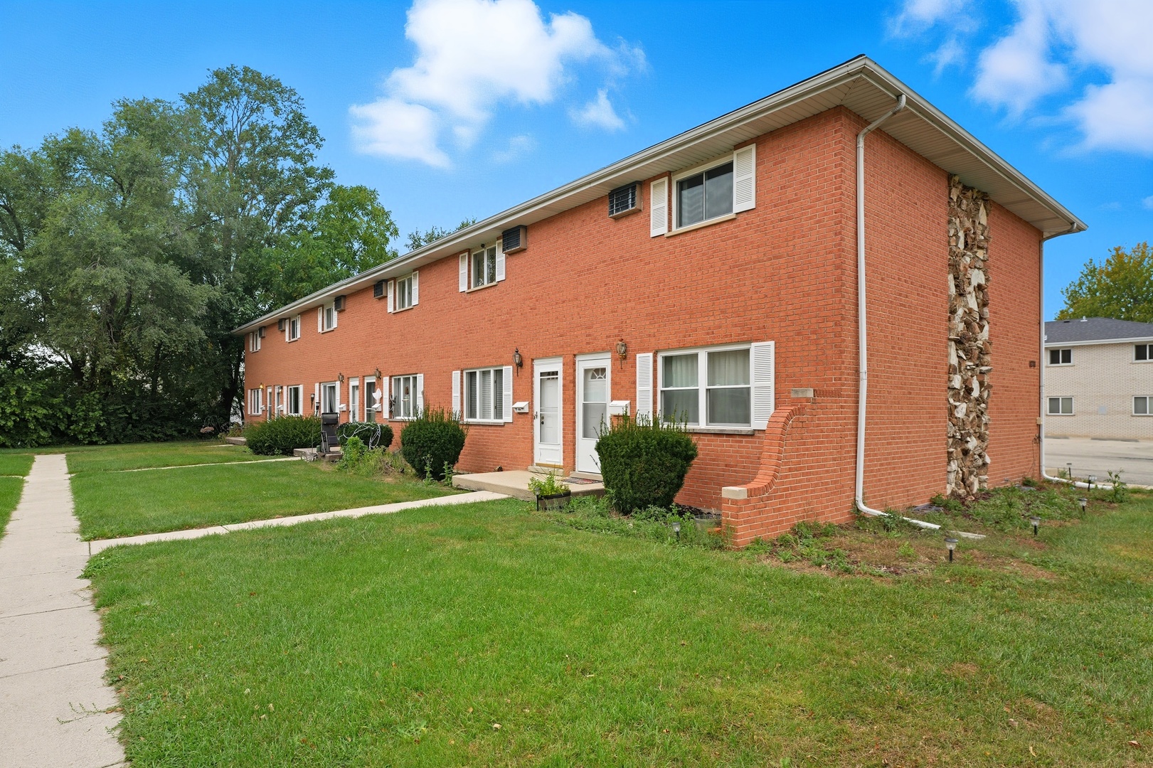 1231 Town Crest Drive, Unit E New Lenox, IL 60451 - Photo 1 of 15 a front view of house with yard and green space