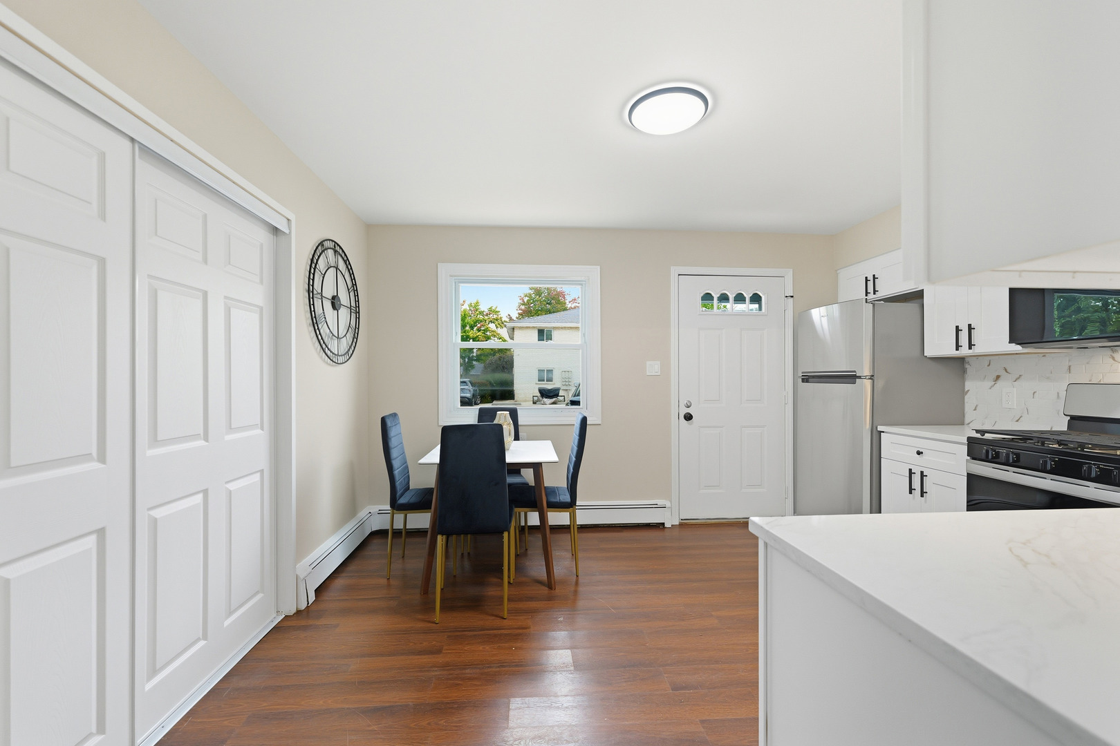 1231 Town Crest Drive, Unit E New Lenox, IL 60451 - Photo 5 of 15 a view of a dining room with furniture and wooden floor