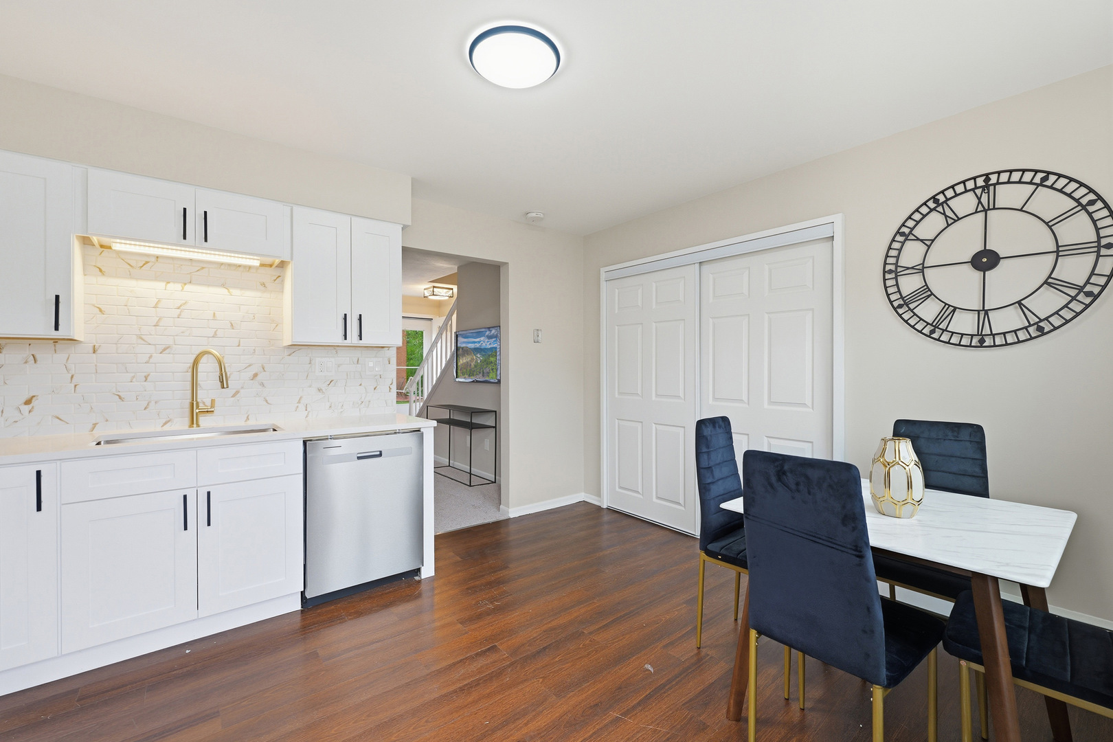 1231 Town Crest Drive, Unit E New Lenox, IL 60451 - Photo 7 of 15 a kitchen with stainless steel appliances granite countertop a table chairs sink and cabinets