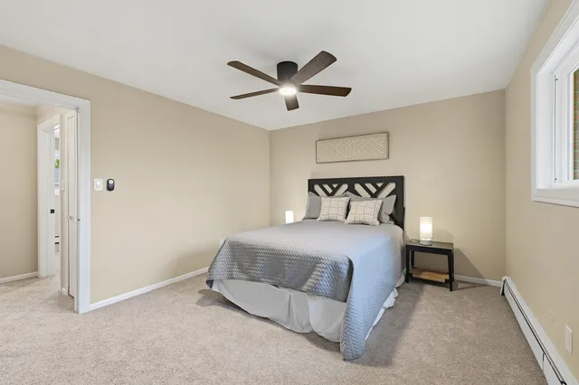 a bedroom with a bed and window